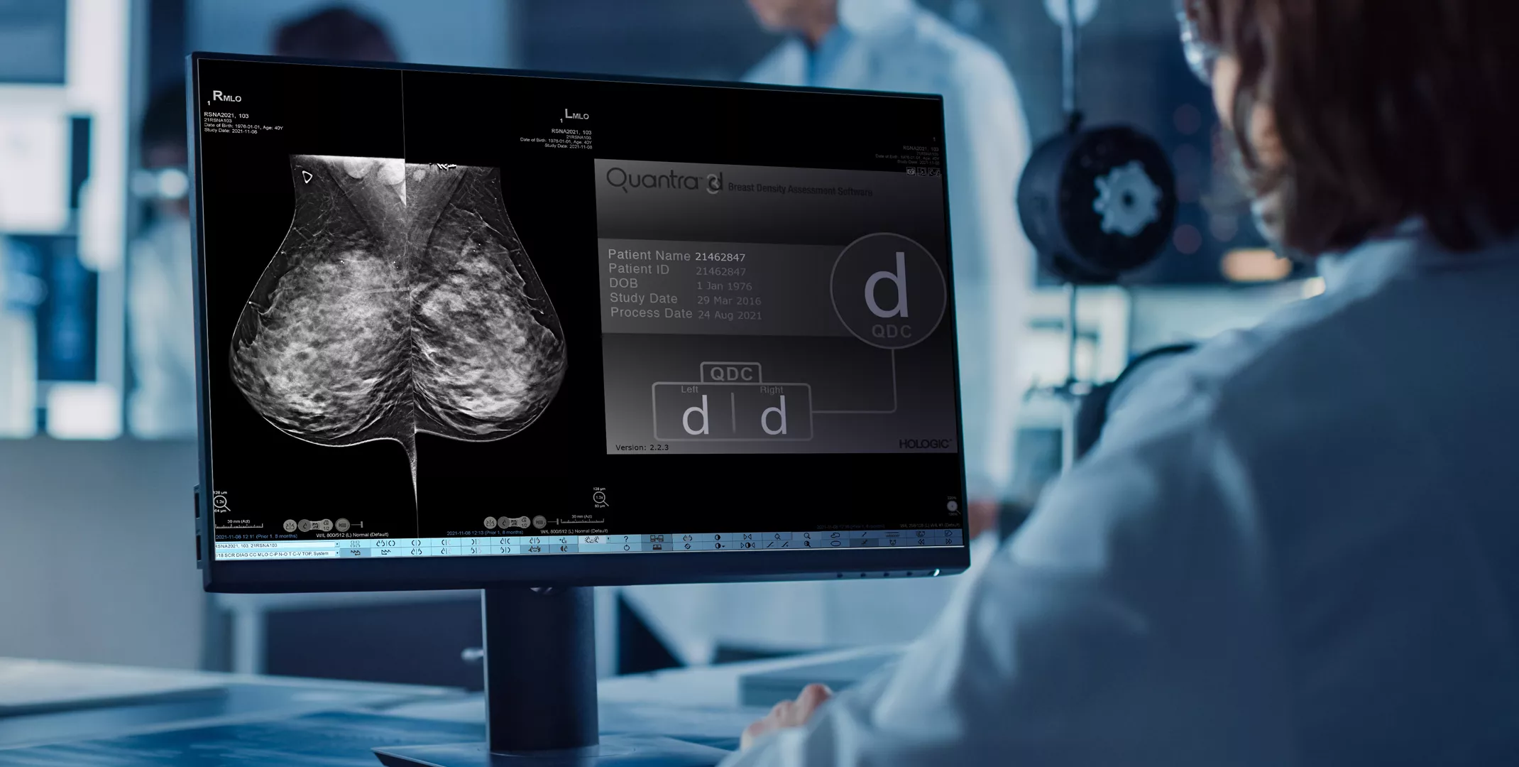Tecnico di laboratorio che esamina le immagini della Tecnologia Quantra™ Hologic su uno schermo